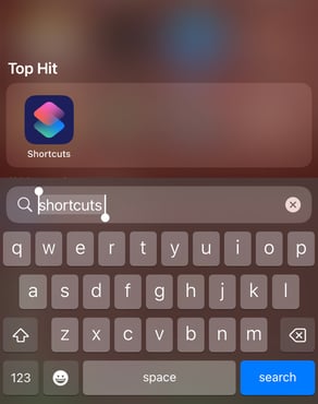 The iPhone search bar with 'shortcuts' typed and the Shortcuts app shown as the top hit.